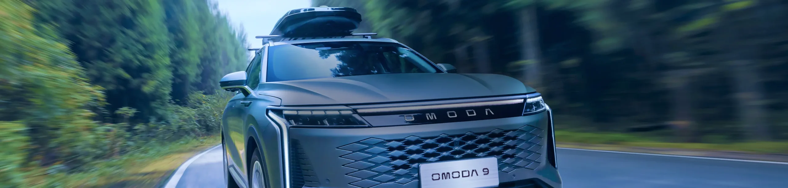 Front view of OMODA 9 in countryside road area