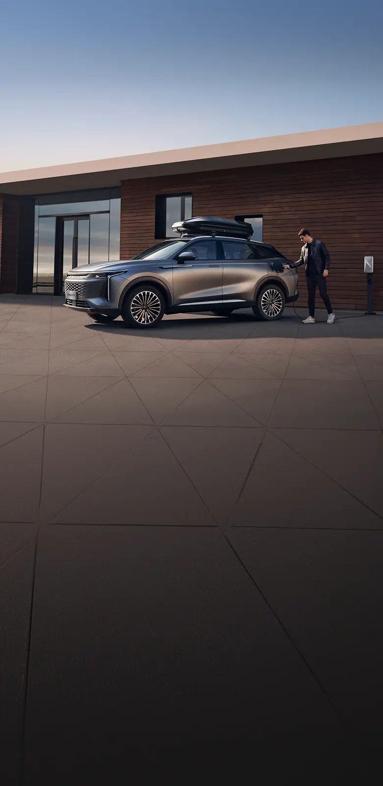 Close up of grey OMODA 9 positioned in front of a wooden building