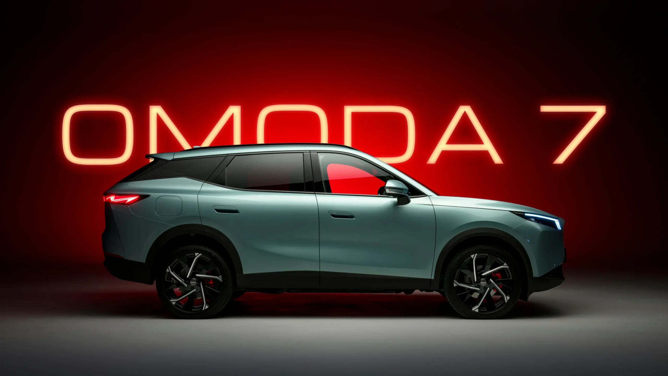 Orange OMODA 7 sign with OMODA 7 parked in front