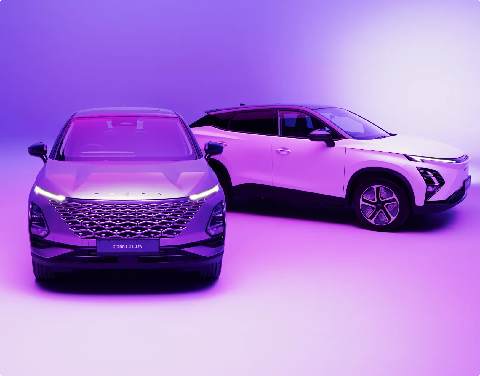 Close up of two OMODA SUvs parked in a purple environment